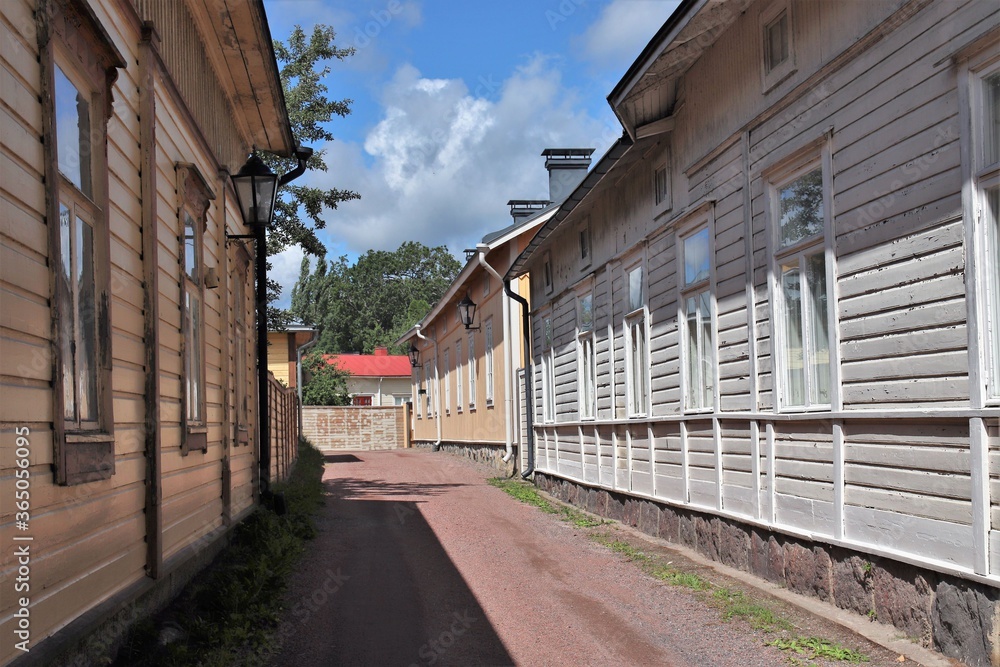 A small street with traditional colorful wooden houses on a wonderful summer day. The photo is taken in Tammisaari town, Finland.