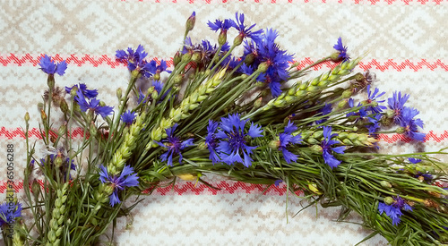 Wreath of blue cornflowers and ears of wheat photo