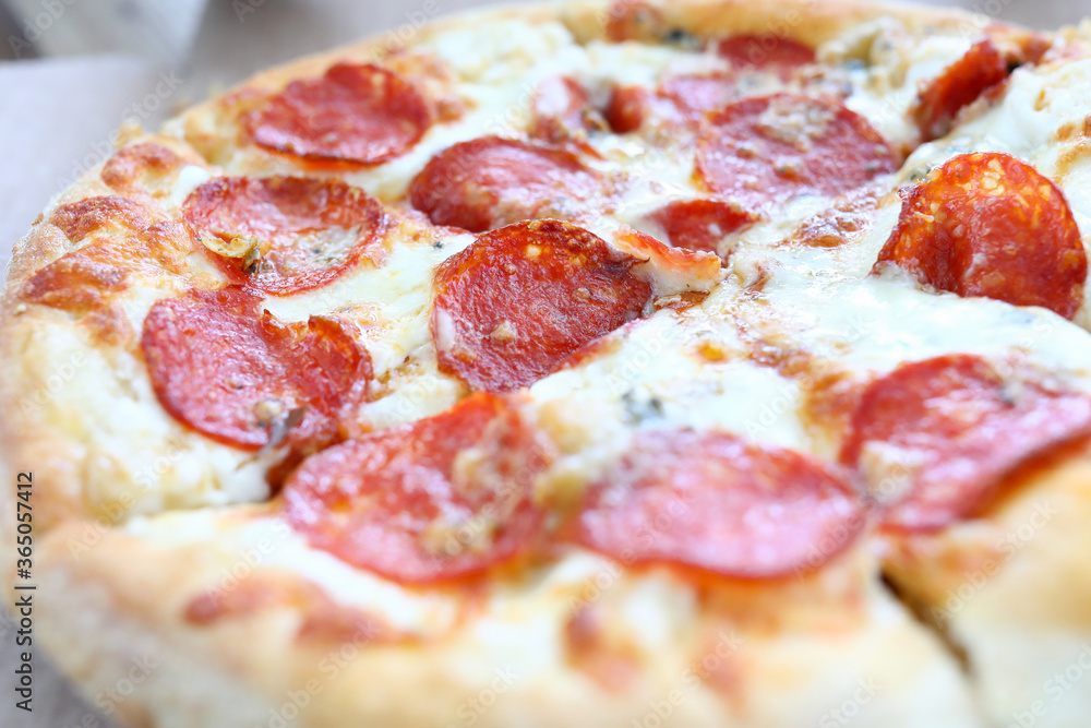 Fresh baked pizza with crusty cheese and hot tasty pepperoni ready to eat Fresh baked pizza with crusty cheese and hot tasty pepperoni ready to eat