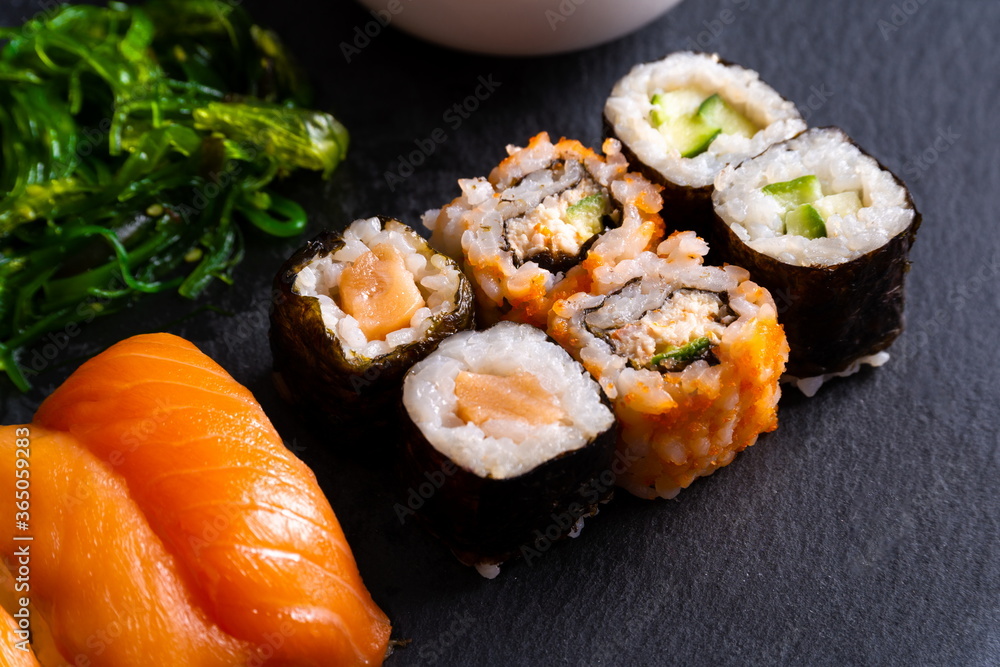 Assorted plate of sushi on black slate plate. Assorted plate of sushi on black slate plate.