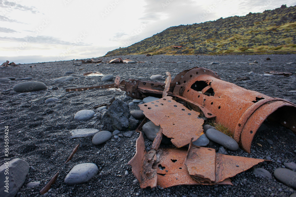 wrecked parts on Black Lava Pearl beach, Djupalonssandur in Iceland 