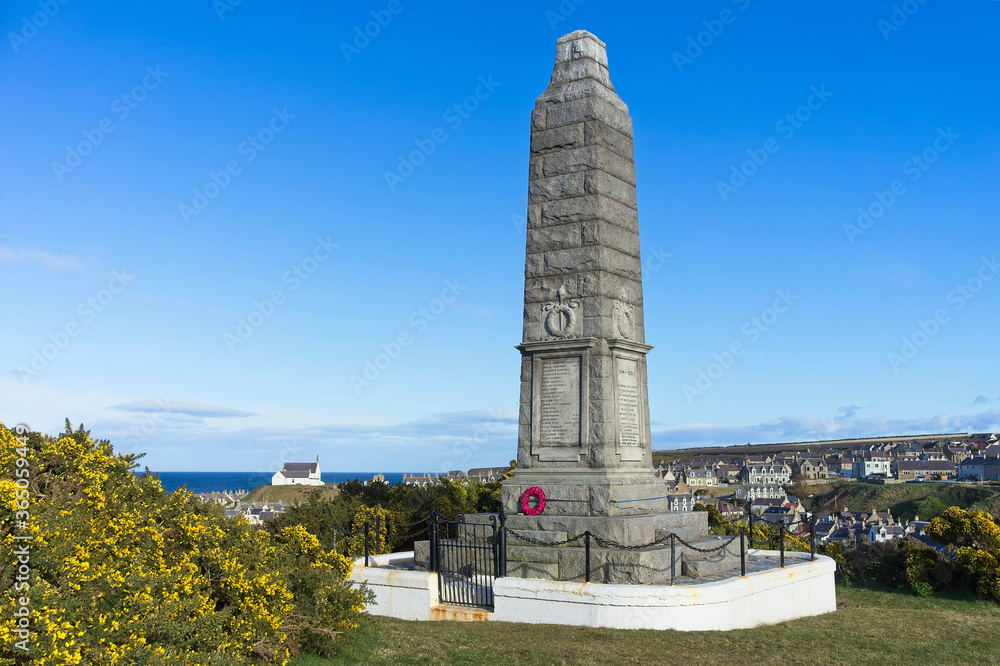 A war memorial overlooking the  fishing village of Findochty in Moray north east of Scotland