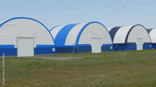 Exterior view of a series of hangars for small aircraft at an airfield outside the city. photo