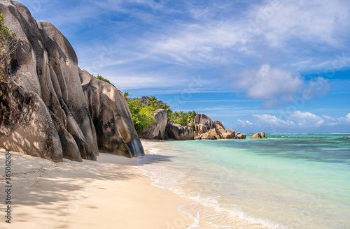 Famous granite boulders in blue lagoon on amazing Anse Source D'Argent tropical beach, La Digue island, Seychelles. 