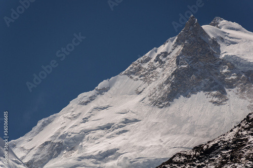 Manaslu summit rises above the far south end of Syancha glacier valley  as seen from Samdo village to Larkya Phedi camp on Manaslu Circuit trek  Manaslu Himal range  Gorkha district  Nepal Himalayas.