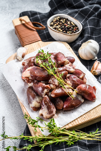 Raw chicken hearts on a cutting board. Organic offal. White background. Top view