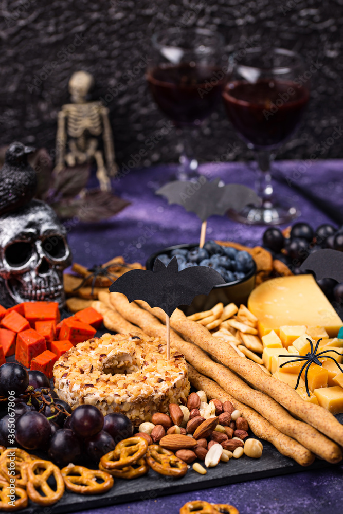Fototapeta premium Cheese plate with berries, nuts and snacks