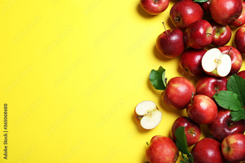 Tasty red apples on yellow background, flat lay. Space for text Tasty red apples on yellow background, flat lay. Space for text