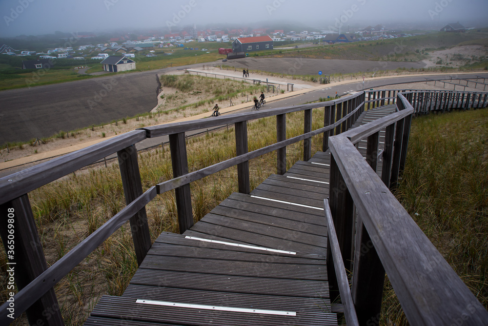 Wooden stairs path over the Dunes in Petten, Netherlands Wooden stairs path over the Dunes in Petten, Netherlands