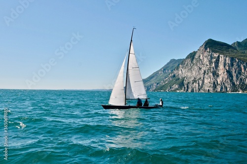 Sports sailing yacht on the high seas. Yacht sailing to the shore on a bright sunny day. Yachting in the sea. Yachting sport. Ocean regatta on sailing yachts. Nautical lifestyle. Freedom concept.