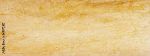 Old brown paper parchment background design with distressed vintage stains and ink spatter and white faded shabby center, elegant antique beige color