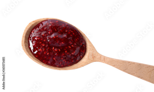 Delicious raspberry jam in wooden spoon isolated on white, top view