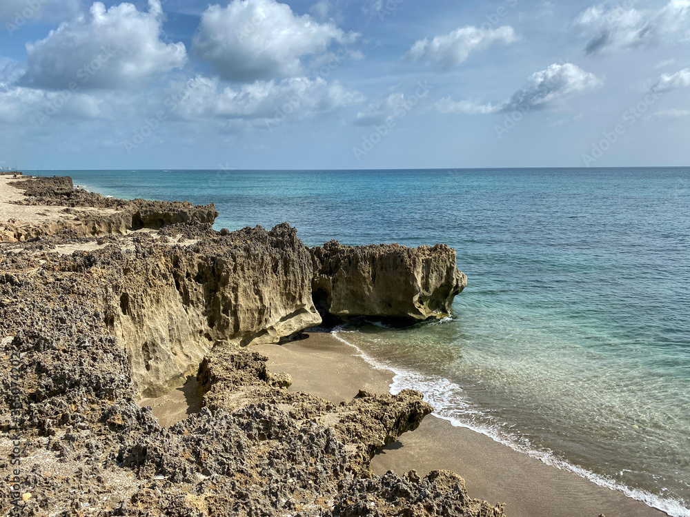 A rocky beach with clear turquoise water in Stuart, FL