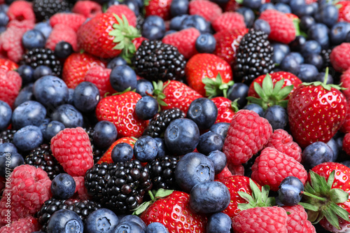 Mix of different ripe tasty berries as background, closeup view