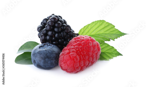 Different ripe tasty berries with green leaves on white background