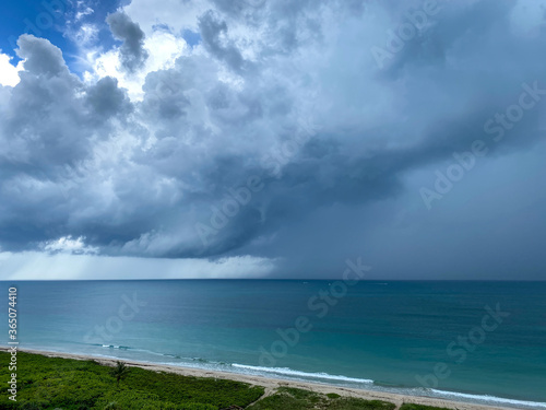 A storm over the colorful Atlantic Ocean with dark clouds.