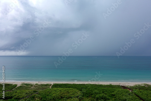 A storm over the colorful Atlantic Ocean with dark clouds.