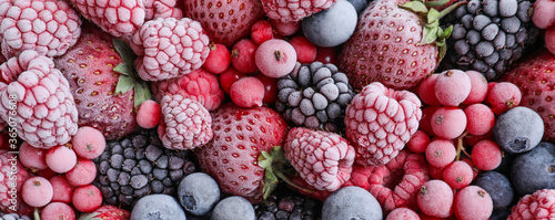 Mix of different frozen berries as background, banner design