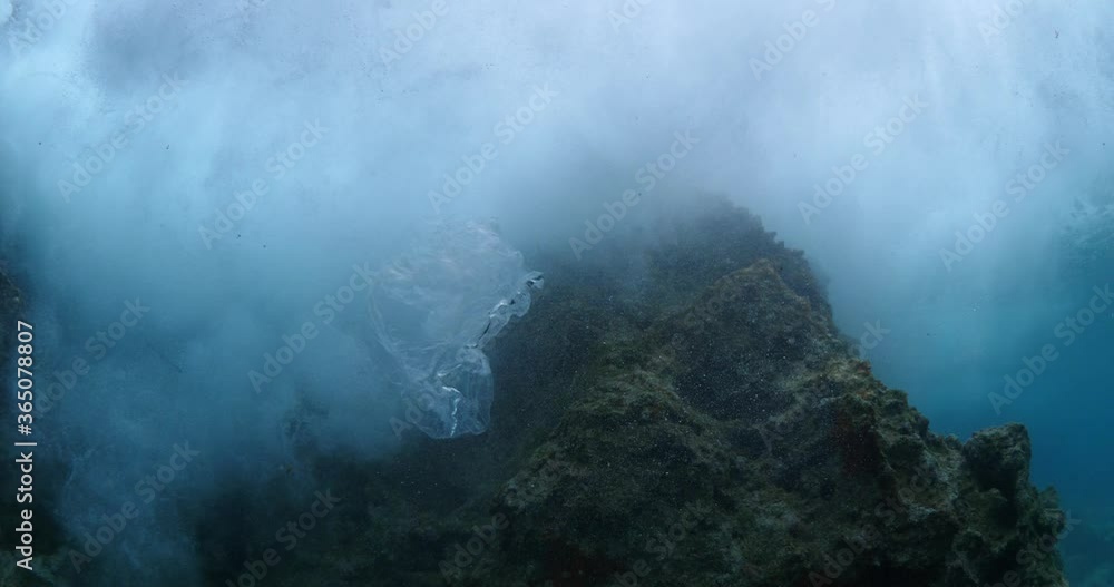 plastic bag underwater bad for fish with sun rays water waves hit to rocks background ocean pollution plastic bag underwater bad for fish with sun rays water waves hit to rocks background ocean pollution