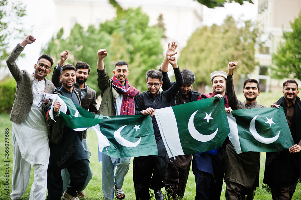 Group of pakistani man wearing traditional clothes salwar kameez or kurta with Pakistan flags. - obrazy, fototapety, plakaty 