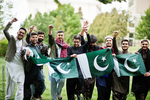 Group of pakistani man wearing traditional clothes salwar kameez or kurta with Pakistan flags. photo