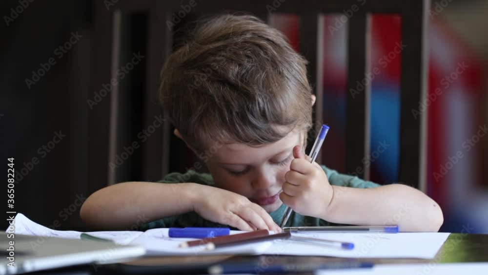 Little toddler boy is playing with pens on father's working place at home Little toddler boy is playing with pens on father's working place at home