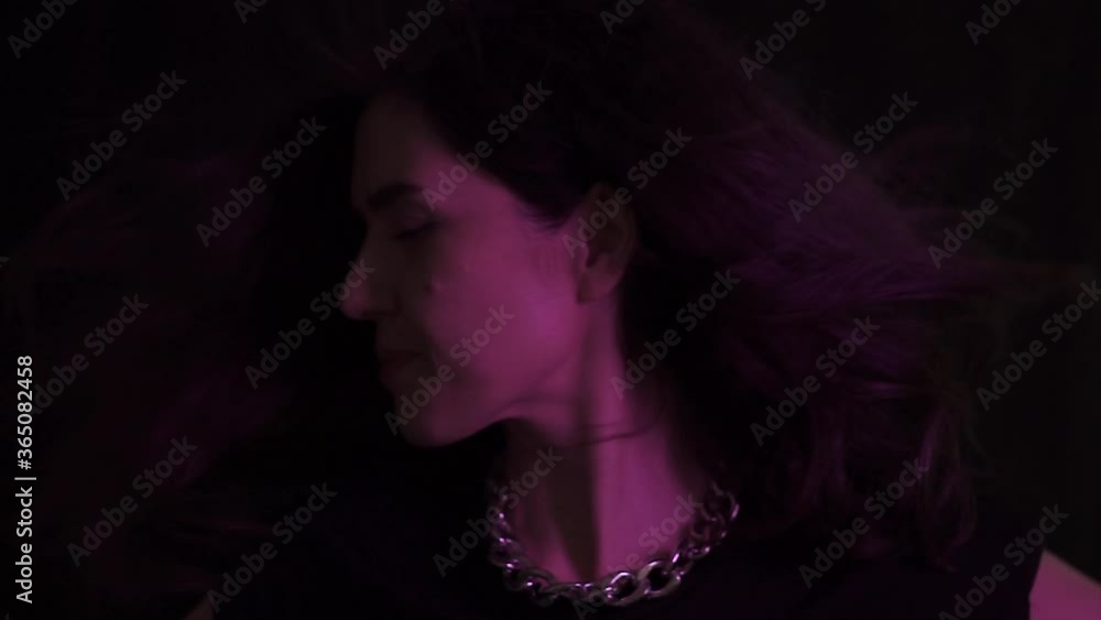 Young beautiful woman is dancing in disco, bar. Lonely, happy drunk woman concept with disco's colorful light. Young beautiful woman is dancing in disco, bar. Lonely, happy drunk woman concept with disco's colorful light.