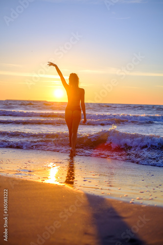 Traveling woman in bikini on beach