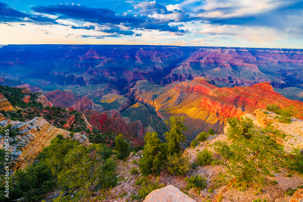 Panoramic image of the colorful Sunset on the Grand Canyon in Grand Canyon National Park from the south rim part,Arizona,USA, on a sunny cloudy day with blue or gloden sky