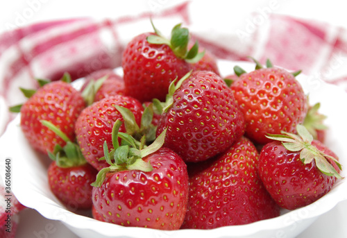 Strawberries in a bowl isolated on a white background. Red strawberries on a white background