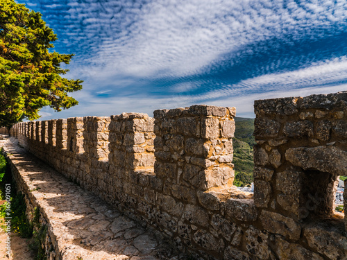 Medieval Castle Battlements. Ancient Moorish defensive wall in Portugal. Beautiful view of Sesimbra City.
