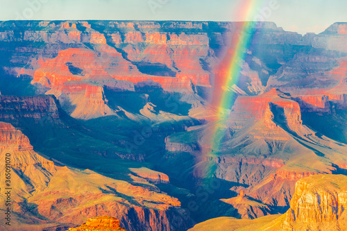 Panoramic image of the colorful rainbow over the Grand Canyon in Grand Canyon National Park from the south rim part,Arizona,USA, sunset on a sunny cloudy day with blue sky
