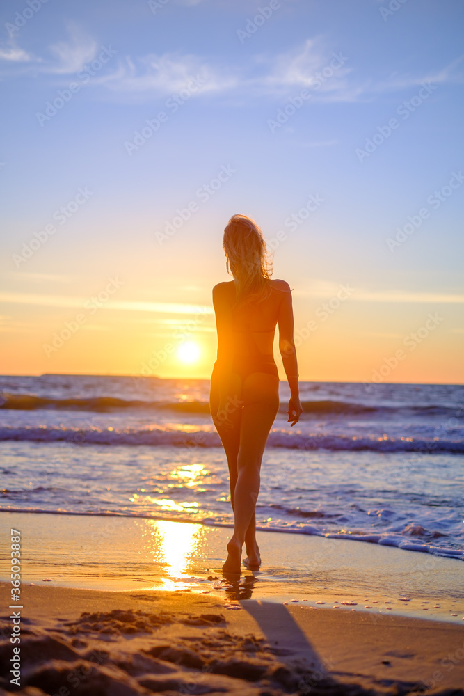 Traveling woman in bikini on beach
