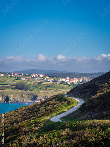 Beaches with waves and cliff at sunset on the Spanish coast