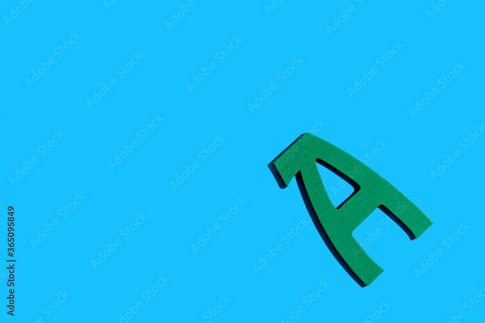 Letter A green colored wooden block with shadow - flat lay Letter A green colored wooden block with shadow - flat lay