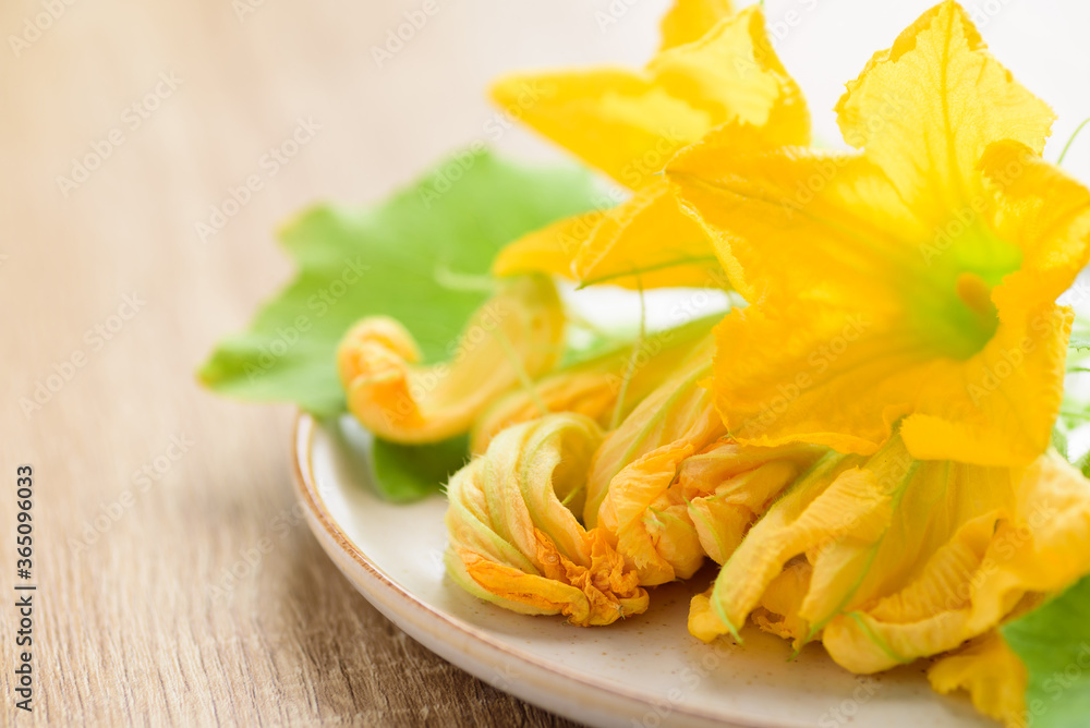 Yellow pumpkin flowers on plate, Edible flower Yellow pumpkin flowers on plate, Edible flower