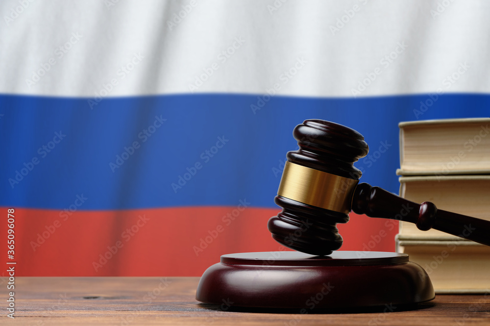 Justice and court concept in Russian Federation. Judge hammer on a flag background