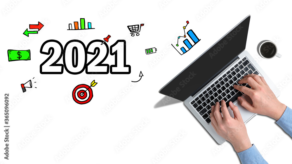 The concept of new achievements and ideas in 2021. Hands typed on a laptop with graphic icons next to it. The concept of new achievements and ideas in 2021. Hands typed on a laptop with graphic icons next to it.