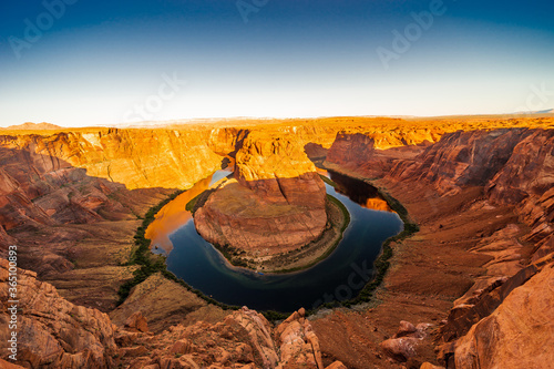 beautiful horseshoe bend on sunny day,Page,Arizona,usa. Panorama of Horseshoe Bend, Page Arizona. The Colorado River and a land mass made of orange sandstone.
