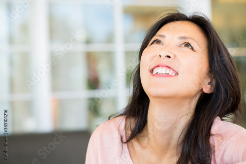 Portrait of an Asian woman smiling.