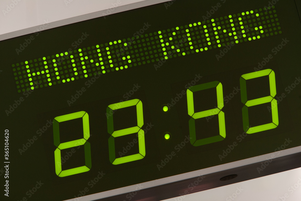 Low angle view of international time zone digital clock on wall in office, Hong Kong