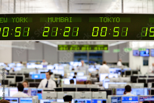 International time zone clock hanging over trading floor at bank