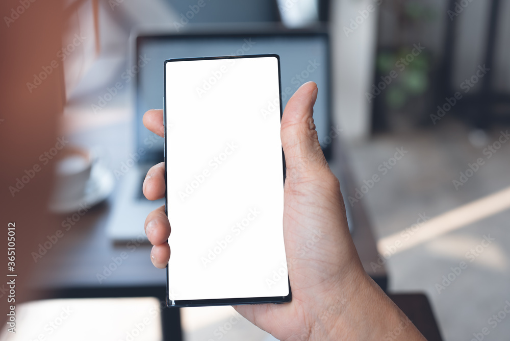 Mockup of man hand using blank screen mobile phone in office Mockup of man hand using blank screen mobile phone in office