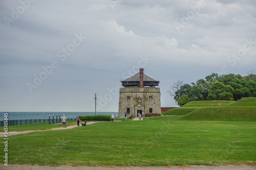 Porter, New York, USA: Visitors at the North Redoubt on the 23-acre grounds of Old Fort Niagara, on a cloudy day on Lake Ontario.