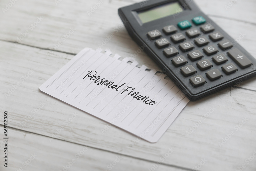Selective focus of calculator and paper written with Personal Finance on white wooden background. Selective focus of calculator and paper written with Personal Finance on white wooden background.