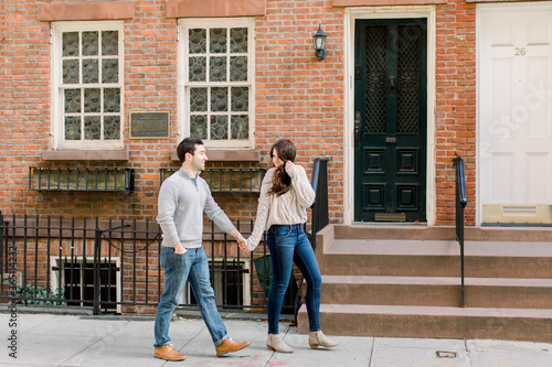 A happy young couple having a romantic moment in an urban setting in West Village in NYC