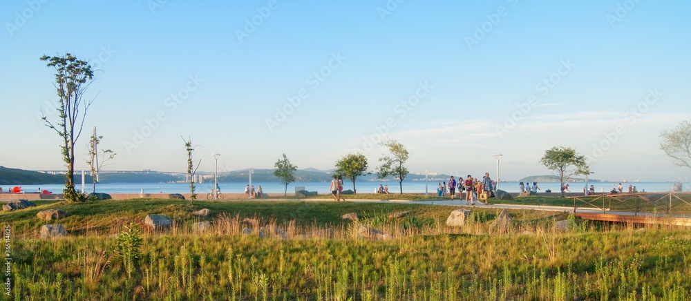 Vladivostok, Russia - August 13, 2013: people walk along the embankment in the newly opened campus of the University of FEFU.