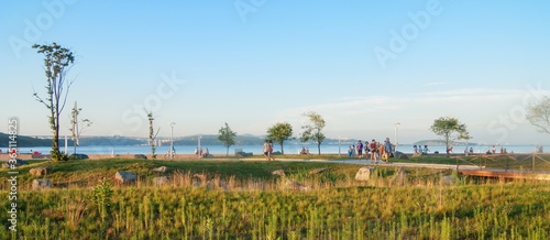 Vladivostok, Russia - August 13, 2013: people walk along the embankment in the newly opened campus of the University of FEFU.