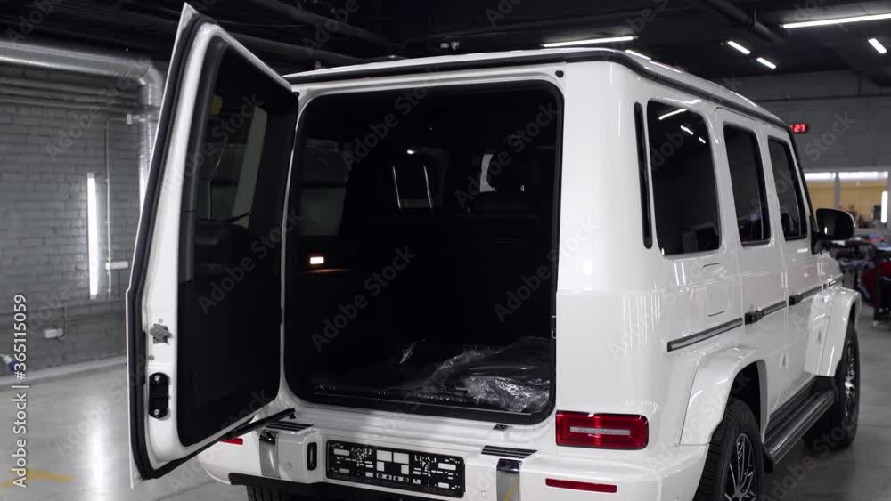 The open trunk of a white car. Rear-eye of a presentable SUV. The open trunk of a white car. Rear-eye of a presentable SUV.