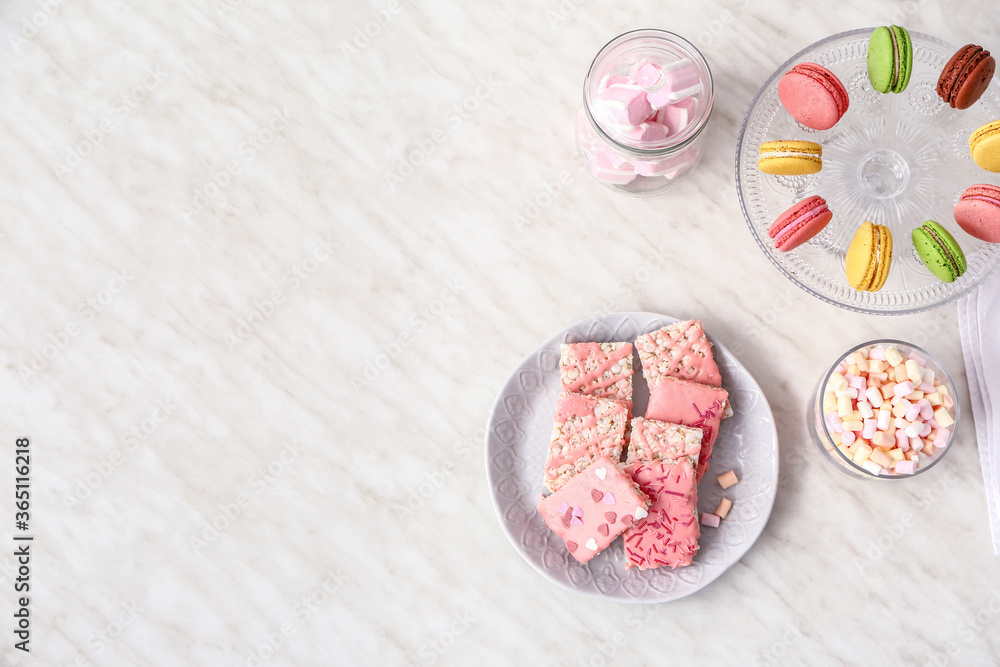 Naklejka premium Plate with crispy rice bars and sweets on white background
